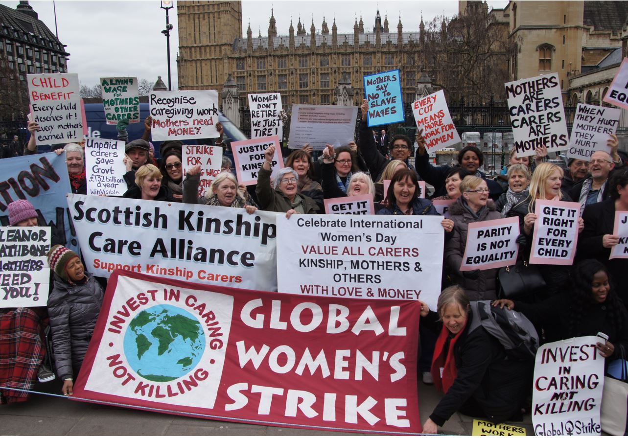 Around 30 kinship and family carers holding placards calling for money for carers and children.  Many from the Scottish Kinship Care Alliance and Global Women's Strike.