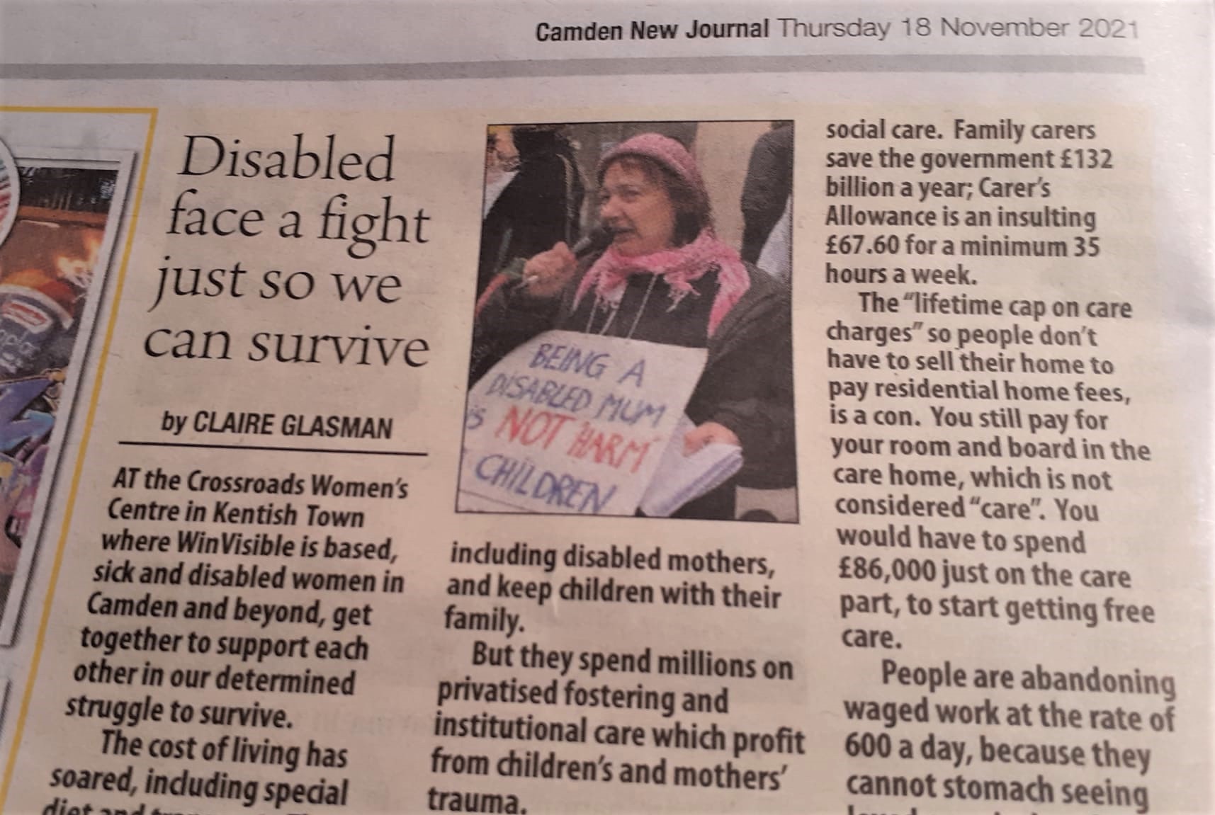 Image of newspaper article in the Camden New Journal.  Photo with article shows a woman speaking on mic and holding placard: Being a disabled mum is NOT "harm" to children.