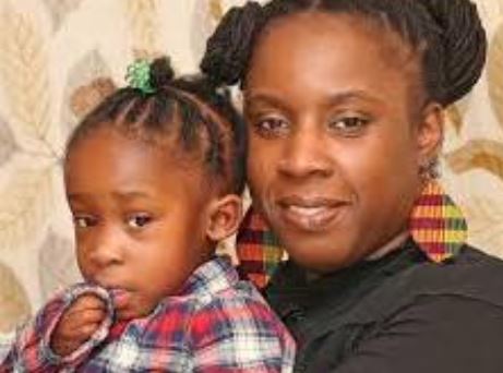 Photo of Nicole, an African Caribbean mum with her daughter on her lap.