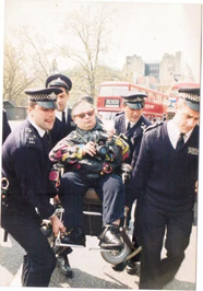 Keith Armstrong, a wheelchair user, is removed by four policemen.