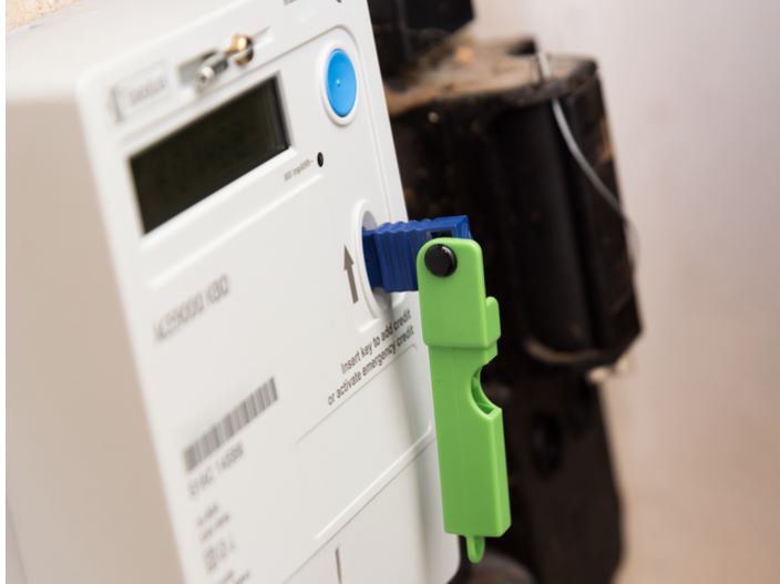 Photo of an electricity meter with green key inserted.