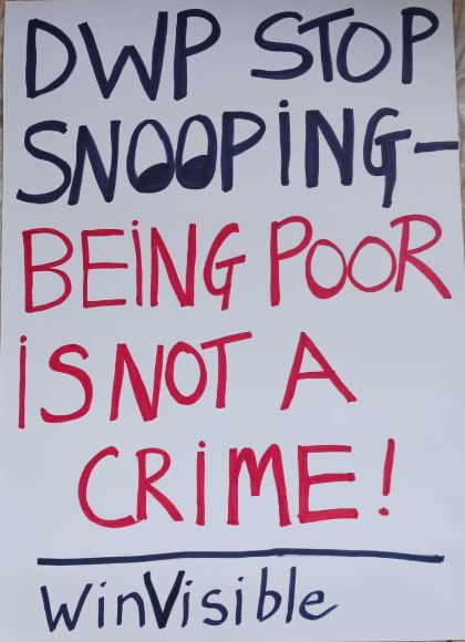 Placard DWP stop snooping -- being poor is not a crime! The two OO are drawn as eyes.