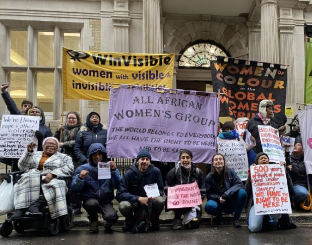 People demonstrating for asylum rights including All African Women's Group, WinVisible, Women of Colour in the Global Women's Strike.