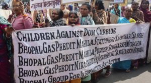 Bhopali women hold a banner with the names of the community organisations demanding justice and compensation.